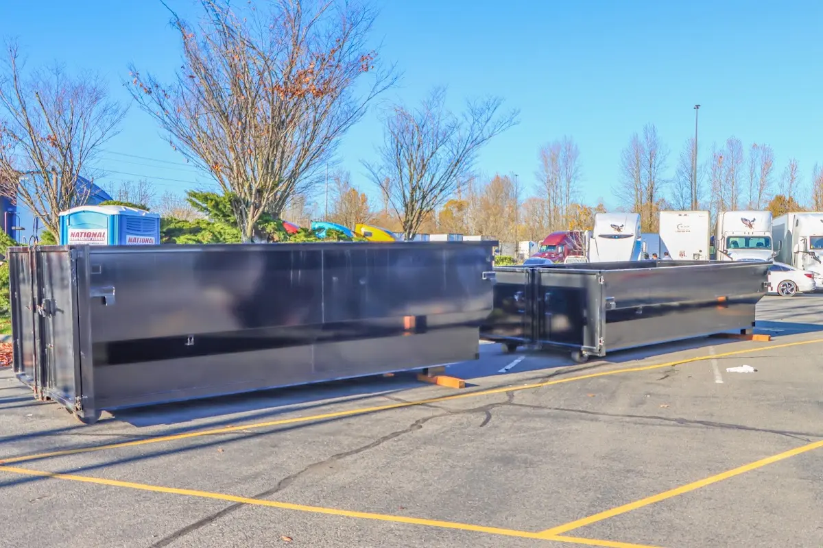 Professional dumpster rental service with roll-off container on residential driveway in Woolwich